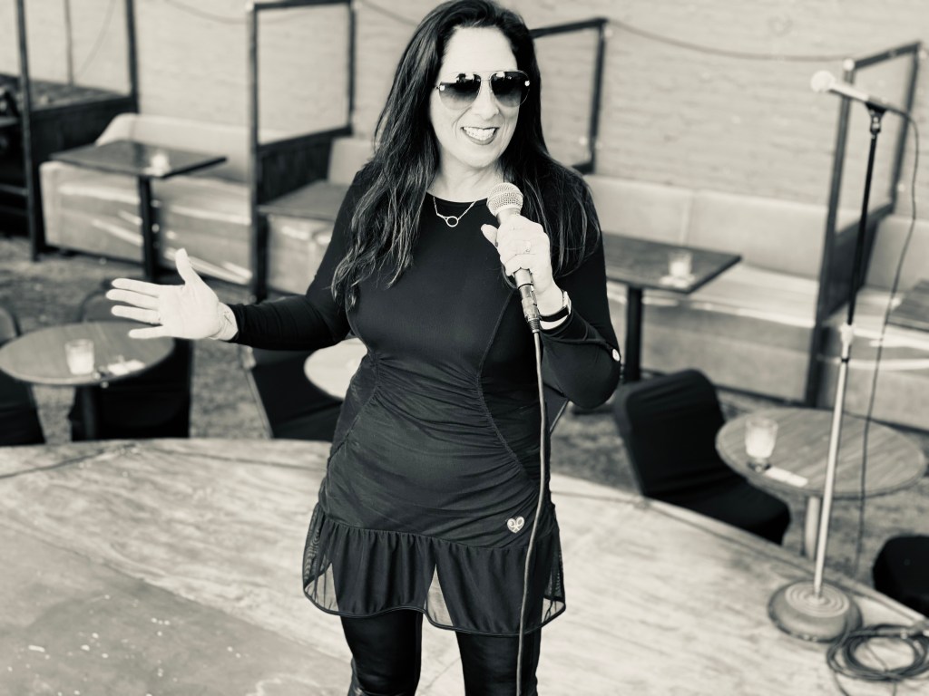 Adeline Arjad speaking on stage with a microphone