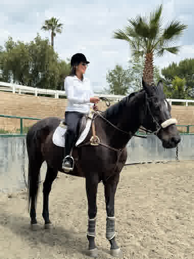 Adeline Arjad with horse at the barn — equestrian passion and connection to nature